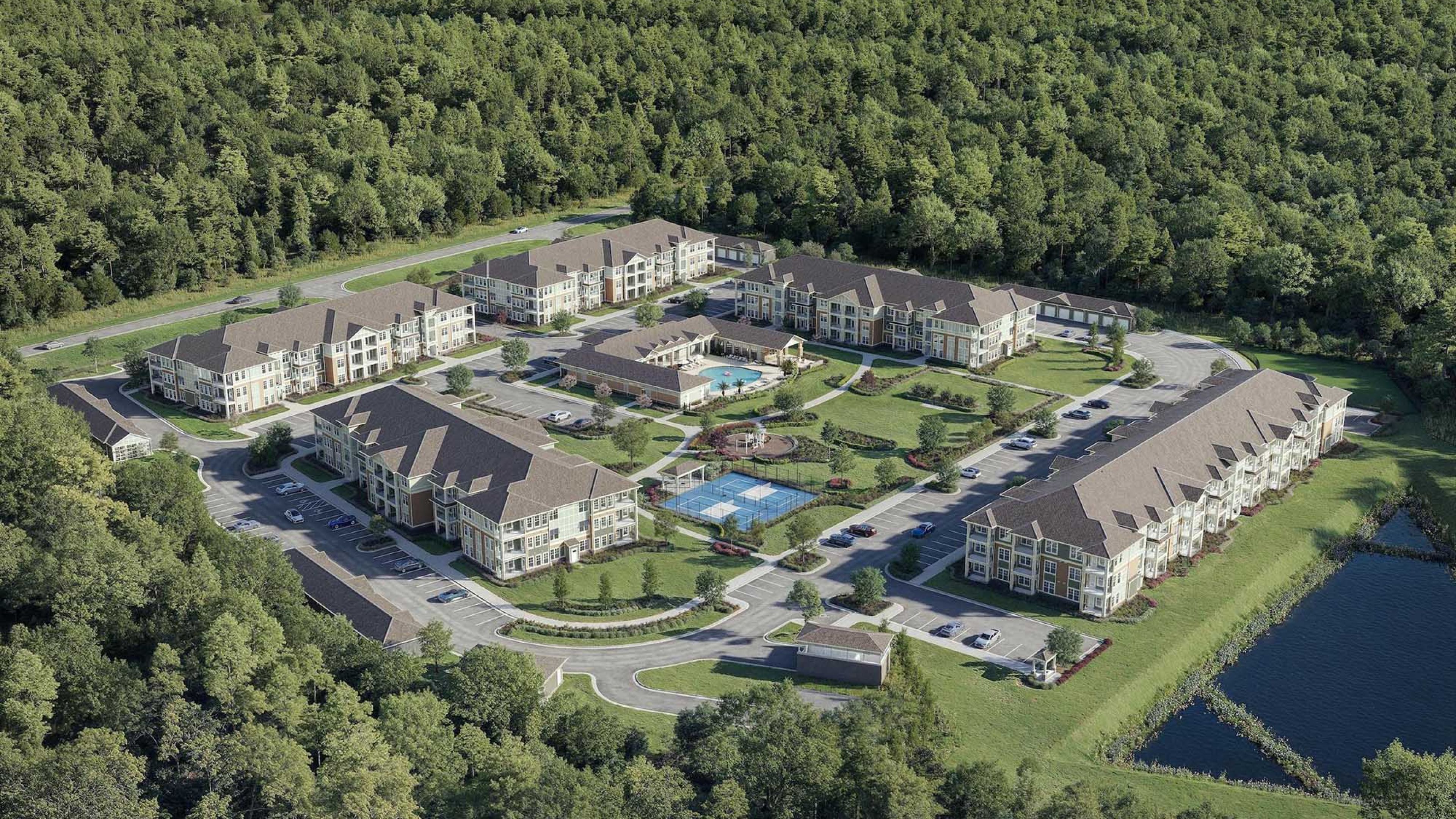 Hawthorne Ocean Isle apartment kitchen area with wrap around kitchen island, stainless steel appliances, and ample cabinet storage